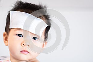 Asian little baby sick with cool fever jel pad on forehead