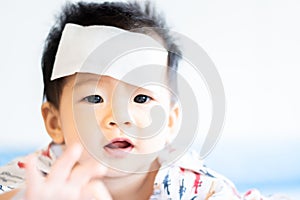 Asian little baby sick with cool fever jel pad on forehead