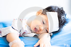 Asian little baby sick with cool fever jel pad on forehead