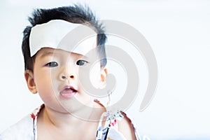 Asian little baby sick with cool fever jel pad on forehead