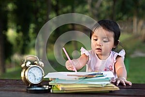Asian little baby toddler drawing at park with copy space photo