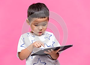 Asian little boy using dgital tablet
