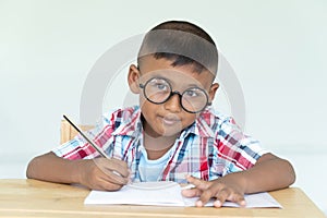 Asian little boy write homework