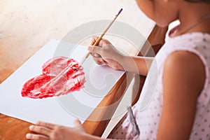 Asian little child girl drawing and painted a heart