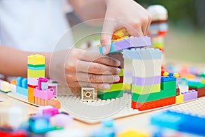 Asian little child girl hand playing with colorful toy blocks