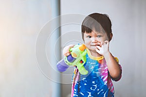 Asian little child girl having fun to play water with water gun in Songkran festival Thailand