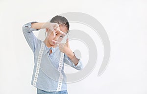 Asian little child girl making frame with fingers  on white background with copy space