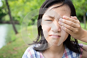 Asian little child girl patient painful,sore eyes,touching,covering with hand or rubbing her eye,feeling eyes pain,female have