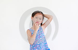 Asian little child girl thinking expression and pointing index finger on cheek with puzzled expression isolated on white