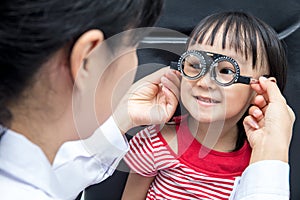 Asian Little Chinese Girl Doing Eyes Examination by ophthalmologist