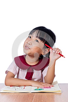 Asian Little Chinese girl drawing with color pencils