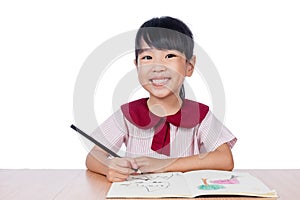 Asian Little Chinese girl drawing with color pencils