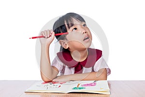 Asian Little Chinese girl drawing with color pencils