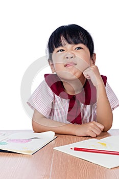 Asian Little Chinese girl drawing with color pencils