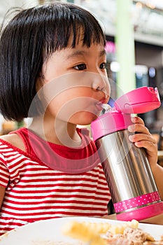 Asian Little Chinese Girl Drinking Water from Stainless Steel Bo