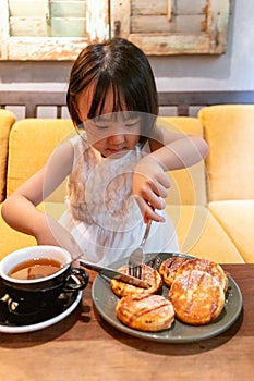 Asian Little Chinese Girl eating pancake