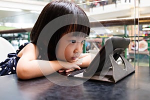 Asian Little Chinese Girl Looking at Digital Tablet