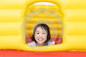 Asian Little Chinese Girl playing at inflatable castle