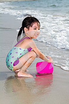 Asian Little Chinese Girl Playing Sand with Beach Toys