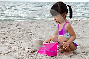 Asian Little Chinese Girl Playing Sand with Beach Toys