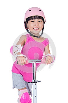 Asian little Chinese girl playing with scooter