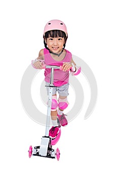 Asian little Chinese girl playing with scooter