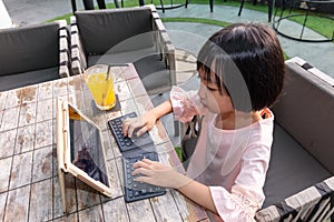 Asian Little Chinese Girl playing with tablet