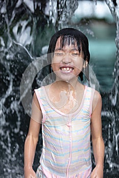 Asian Little Chinese Girl playing at water park