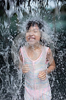 Asian Little Chinese Girl playing at water park