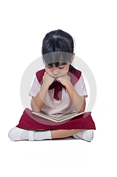 Asian Little Chinese girl sitting on floor and reading book