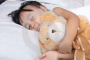 Asian little Chinese girl sleeping with teddy bear