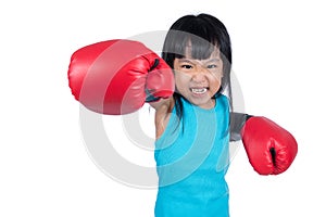 Asian Little Chinese Girl Wearing Boxing Glove With Fierce Expression