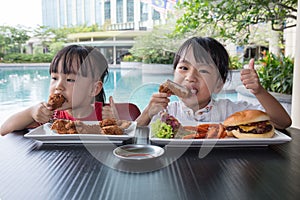 Asian Little Chinese Girls Eating Burger and Fried chicken