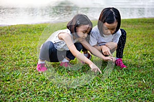 Asian Little Chinese Sisters playing at the park