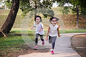 Asian Little Chinese Sisters running happily