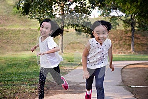 Asian Little Chinese Sisters running happily