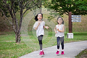 Asian Little Chinese Sisters running happily