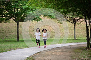 Asian Little Chinese Sisters running happily