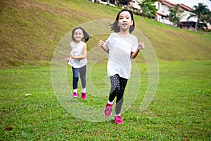 Asian Little Chinese Sisters running happily