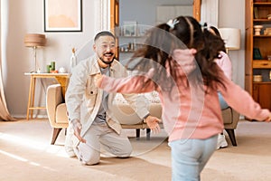 Asian Little Daughter Running To Embrace Daddy At Home