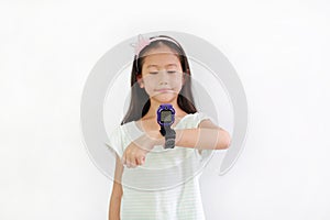 Asian little girl child using smart watch video camera against white background. Focus at smart watch at his hands