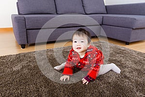Asian little girl crawling on carpet
