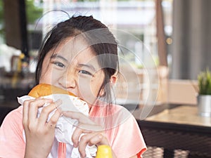 Asian little girl eating a burger. asian Children eat chicken cheese Hamburger