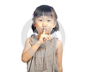 Asian little girl finger up to lips for making a quiet gesture i photo