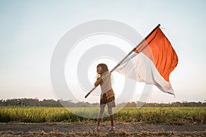 Asian little girl flapping Indonesian flag