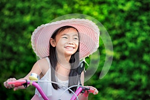 Asian little girl with her bicycle
