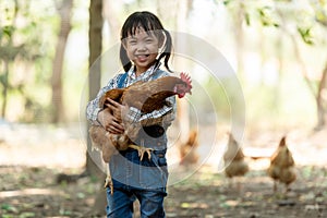 Asian little girl hold eggs in hand chicken a layer and house farm eggs.