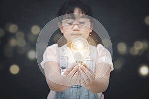 Asian Little girl holding the light bulb  in graph Screen Icon of media screen,Technology Process System Business,E-learning Educa