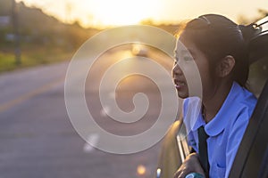 Asian little girl looking something out the car. In the morning, the girl was looking at something outside the car window on the