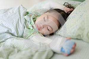 Asian little girl lying in bed at hospital, Baby girl sick from skin allergies.